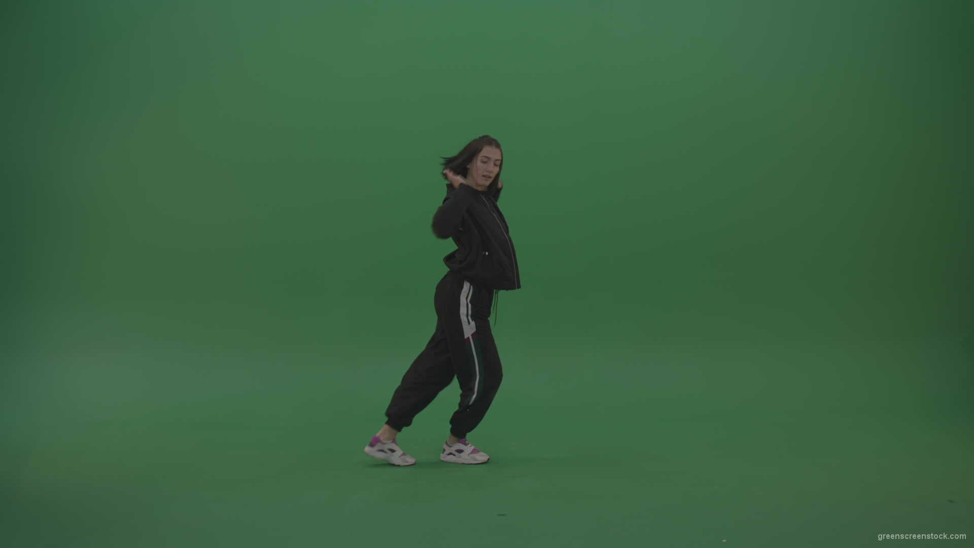 Incredible_Dance_Hip_Hop_Moves_From_Young_Brunette_Female_Wearing_Black_Sweat_Suite_And_White_Trainers_On_Green_Screen_Wall_Background_002 Green Screen Stock