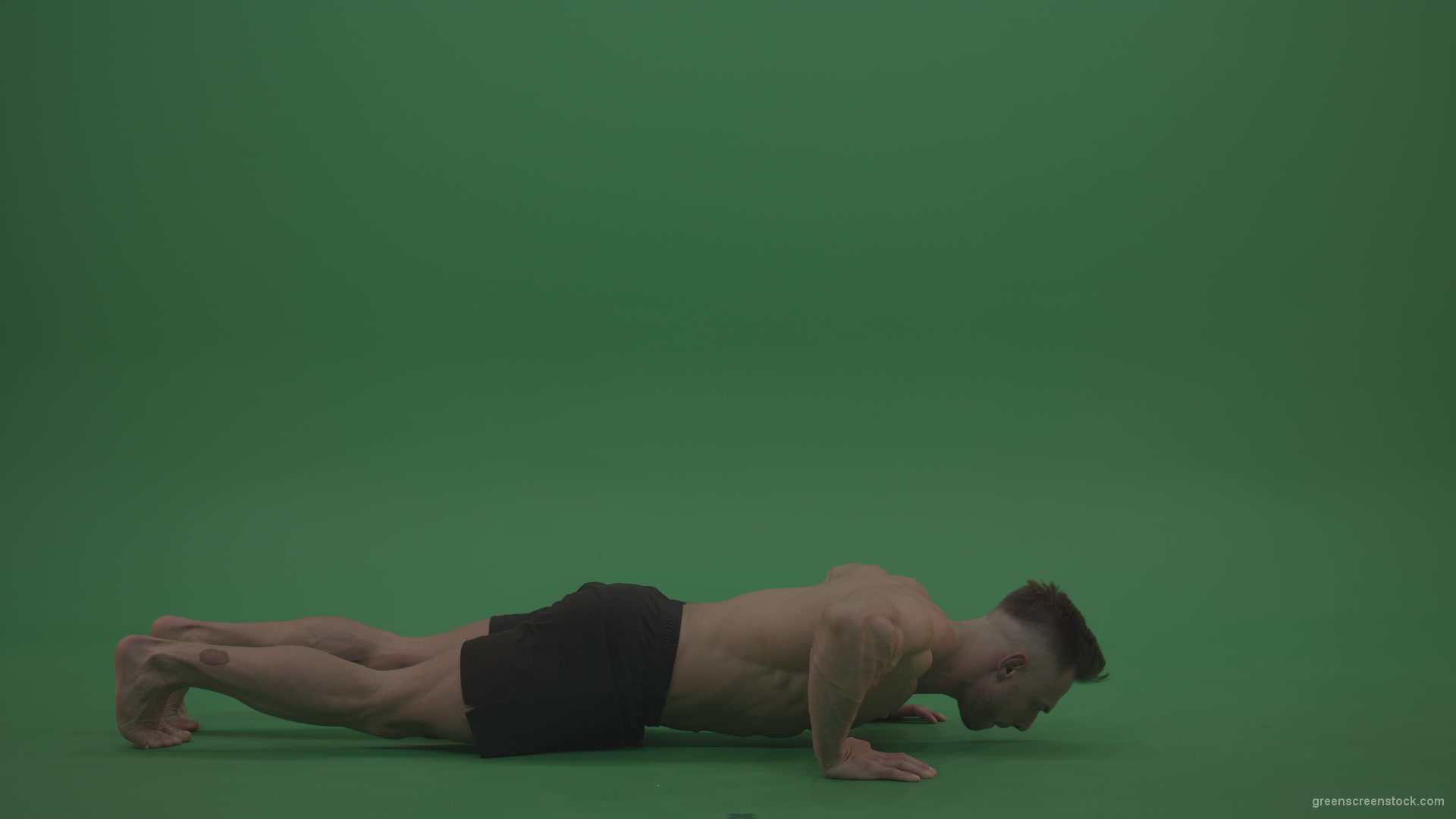 Young_Bodybuilder_Starts_Working_Out_From_Crouching_Terminator_Position_Does_Pull_Ups_Turns_Back_To_The_Start_Position_On_Green_Screen_Wall_Background_007 Green Screen Stock