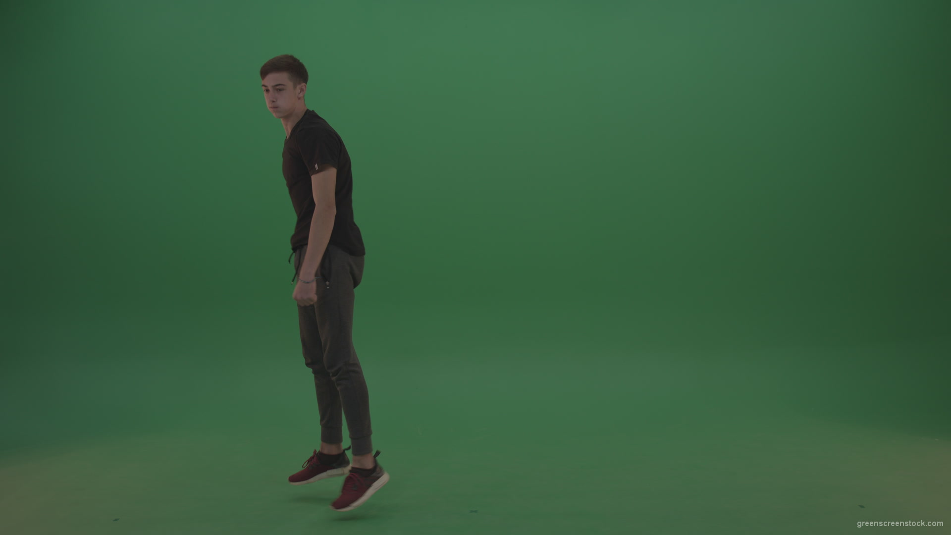 Young_Dark_Hair_Boy_Does_Perfect_Scoot_Back_360_Freerun_Parkour_Trick_On_Green_Screen_Wall_Background_009 Green Screen Stock