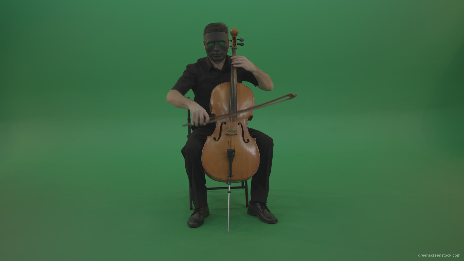 Full-size-man-in-black-wear-and-mask-play-violoncello-cello-strings-music-instrument-isolated-on-green-screen_002 Green Screen Stock