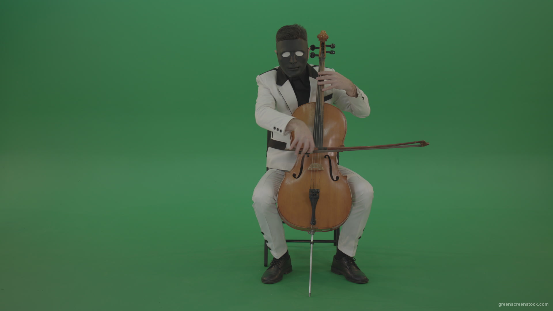 Man-plays-on-a-cello-in-a-white-suit-and-a-black-mask-with-white-eyes_001 Green Screen Stock