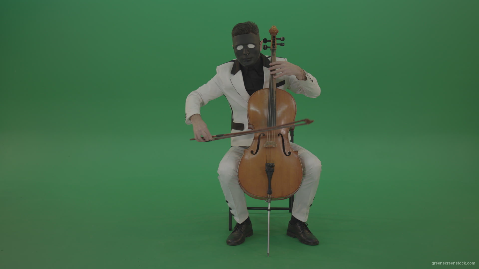 vj video background Man-plays-on-a-cello-in-a-white-suit-and-a-black-mask-with-white-eyes_003