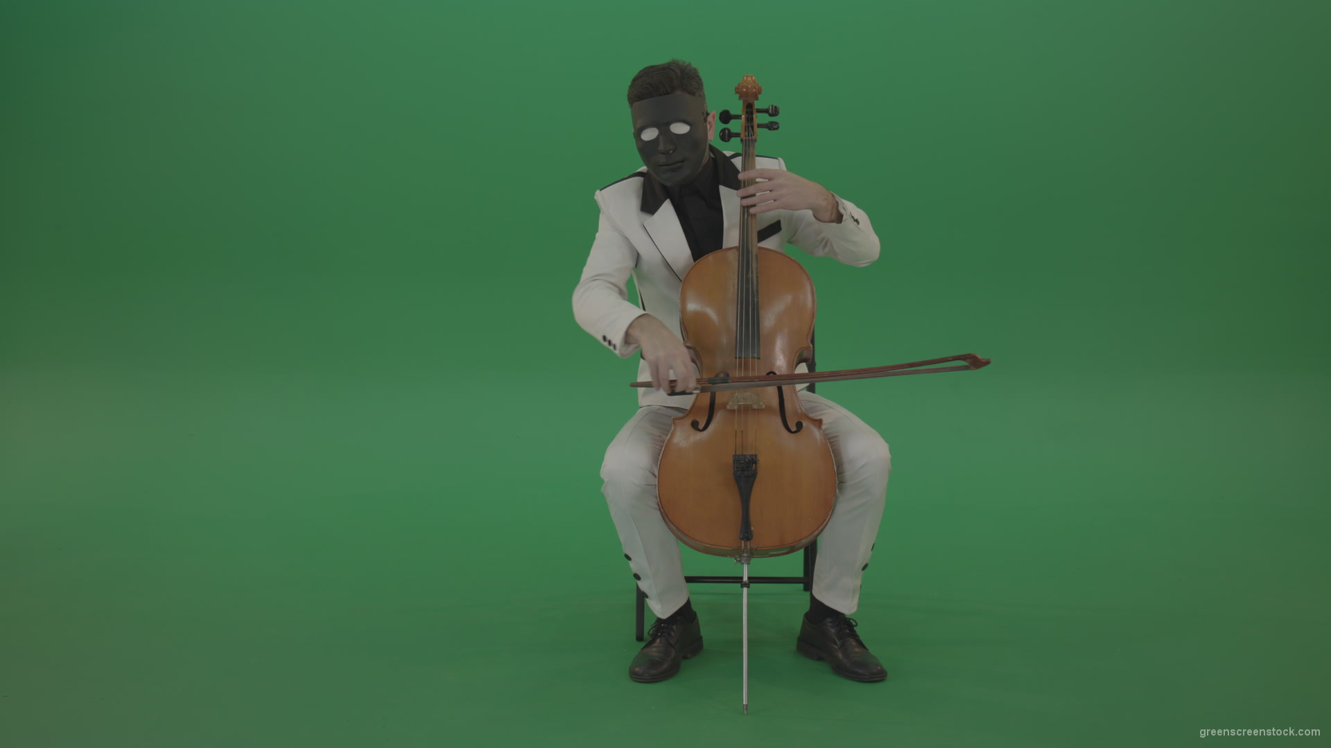 Man-plays-on-a-cello-in-a-white-suit-and-a-black-mask-with-white-eyes_008 Green Screen Stock
