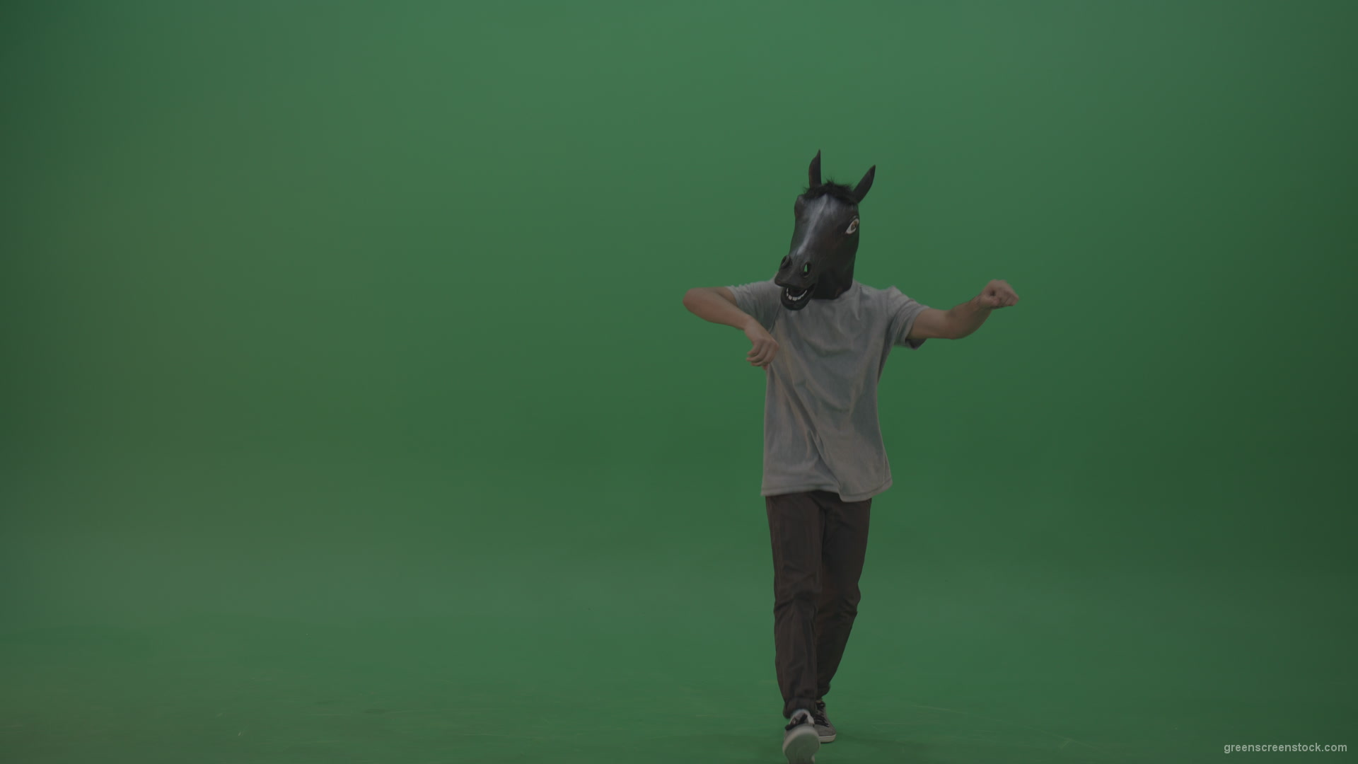 Boy-in-grey-wear-and-horse-head-costume-dances-over-green-screen-background_004 Green Screen Stock