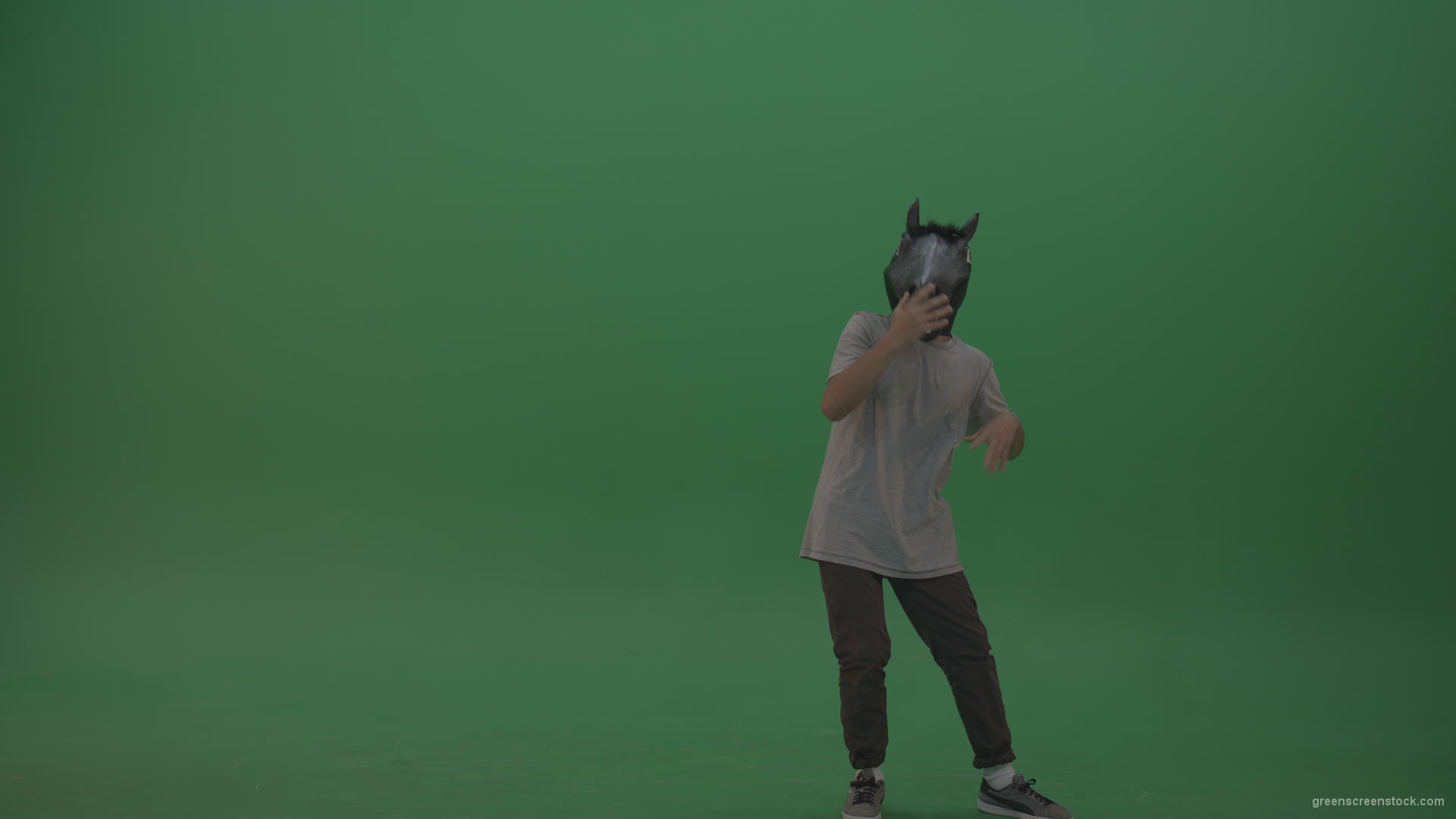 Boy-in-grey-wear-and-horse-head-costume-dances-over-green-screen-background_006 Green Screen Stock
