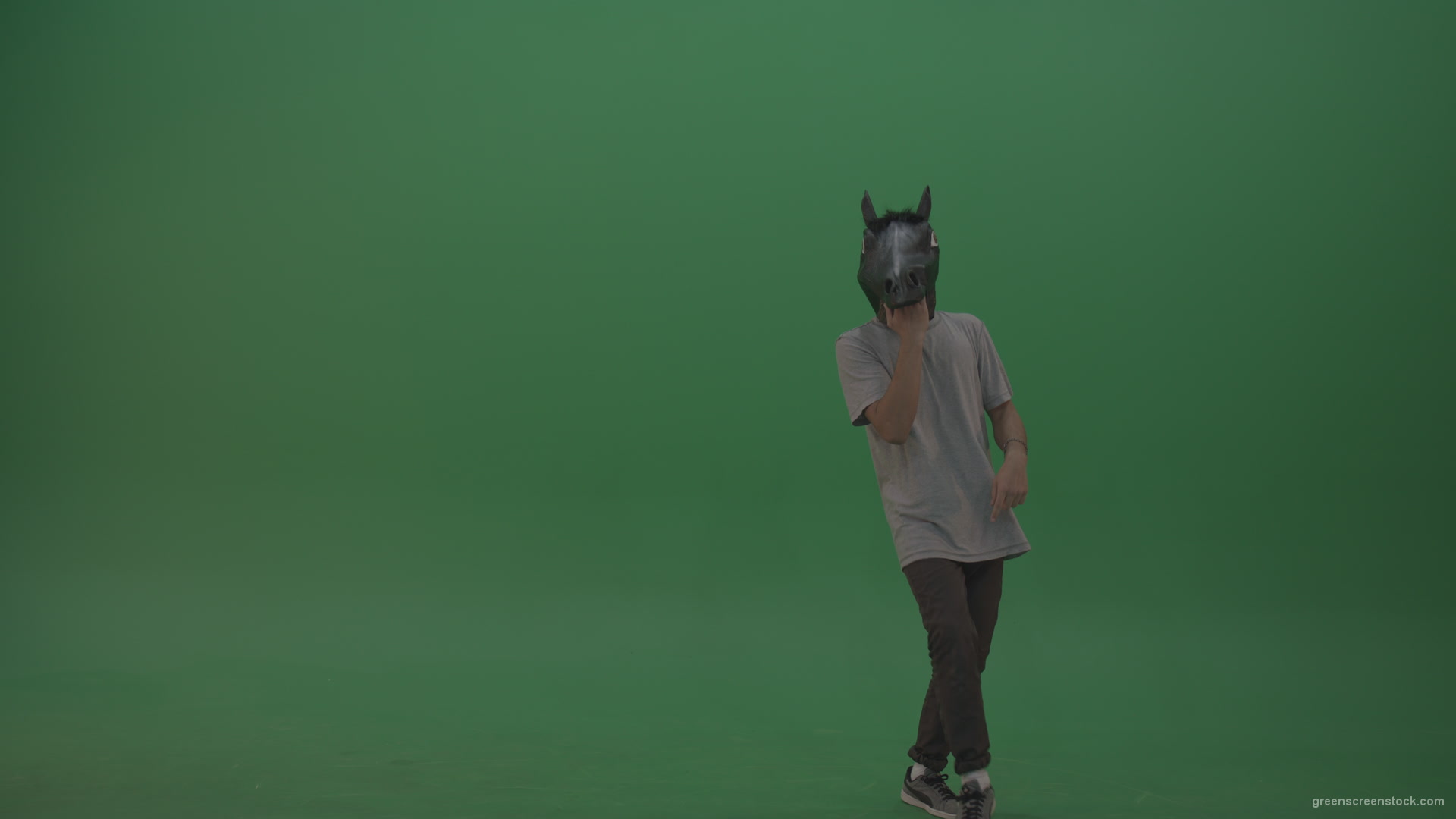Boy-in-grey-wear-and-horse-head-costume-dances-over-green-screen-background_007 Green Screen Stock