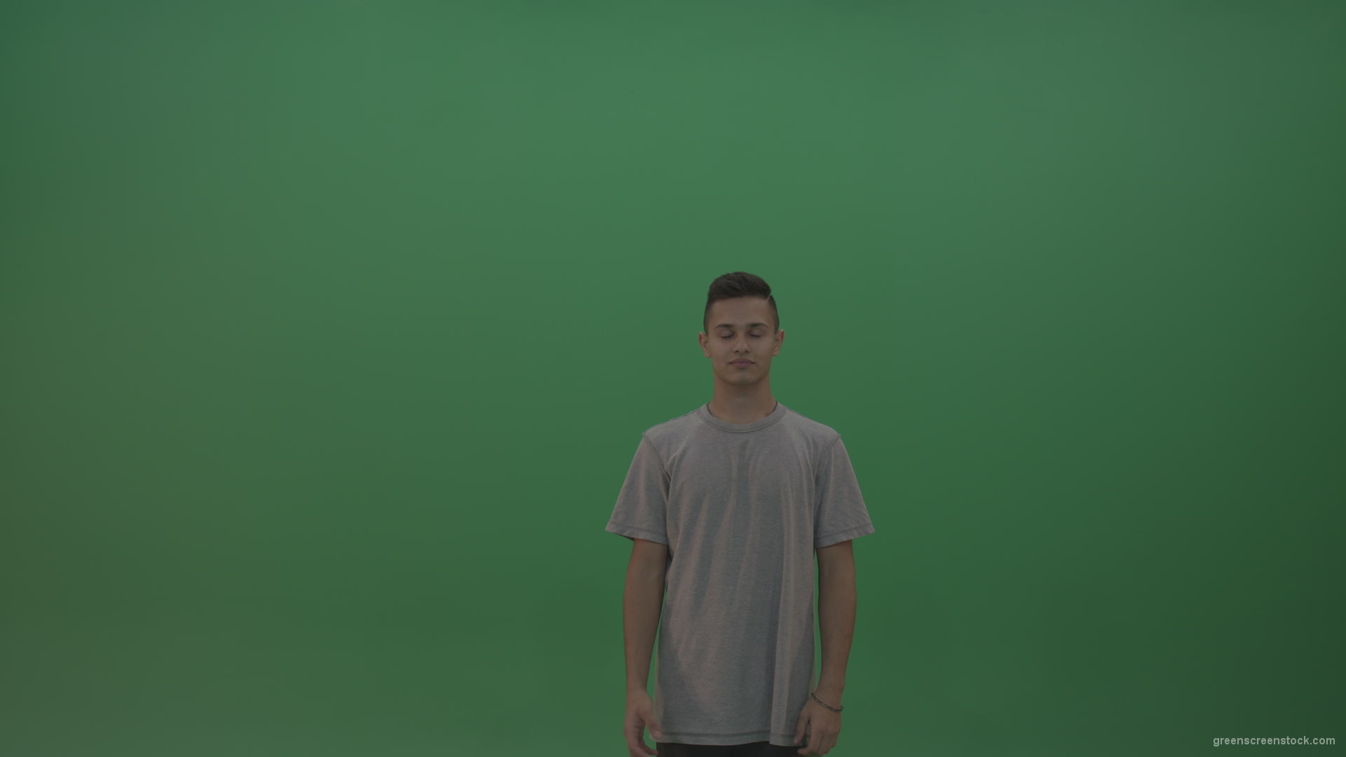 Boy-in-grey-wear-expresses-approval-by-giving-thumbs-up-over-green-screen-background_002 Green Screen Stock