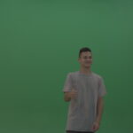 vj video background Boy-in-grey-wear-expresses-approval-by-giving-thumbs-up-over-green-screen-background_003