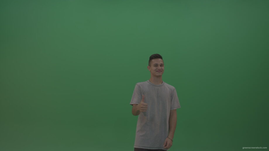 vj video background Boy-in-grey-wear-expresses-approval-by-giving-thumbs-up-over-green-screen-background_003