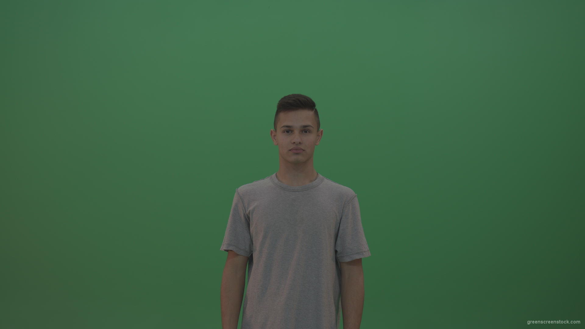Boy-in-grey-wear-expresses-disappointment-over-green-screen-background_001 Green Screen Stock