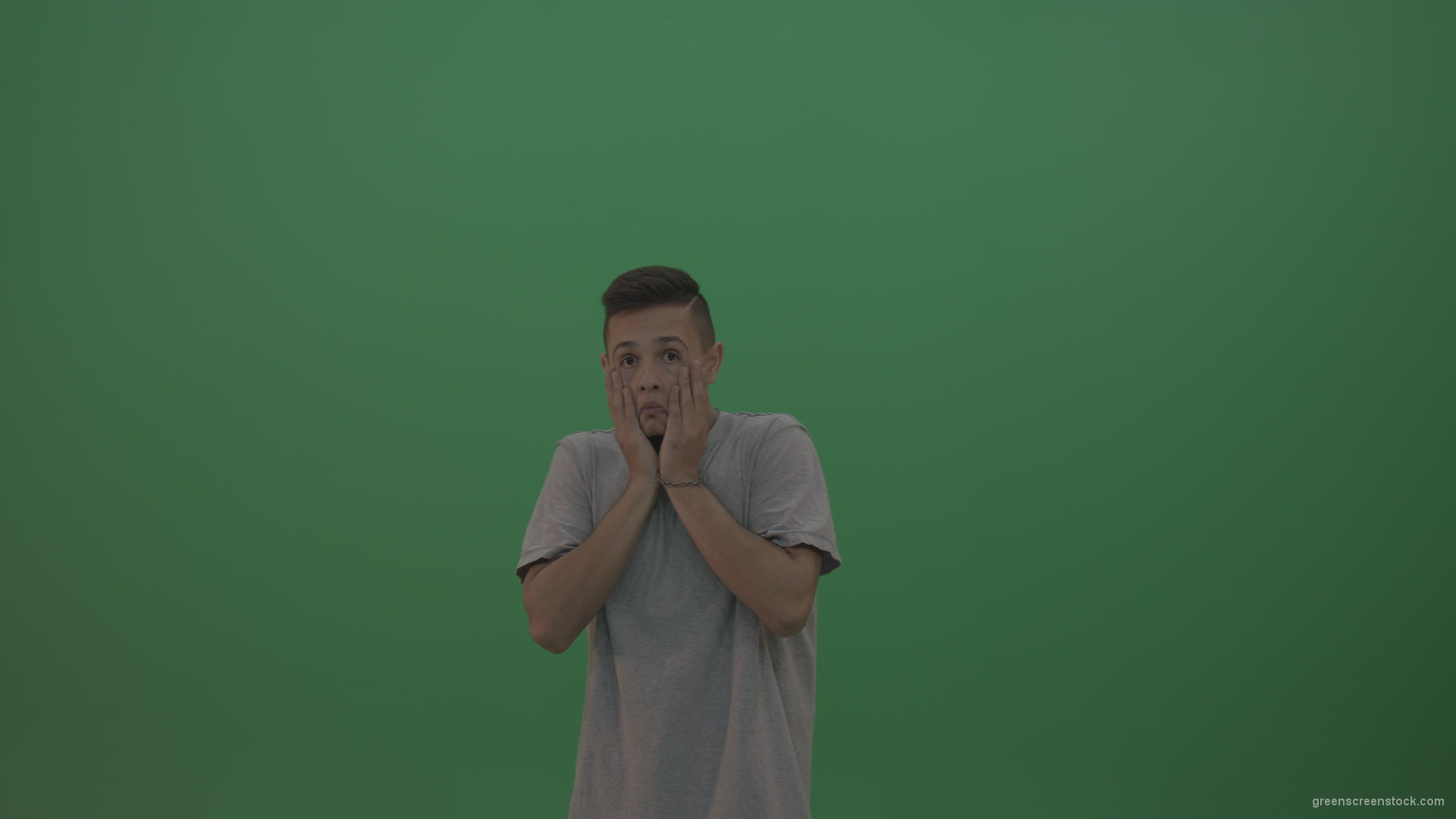 Boy-in-grey-wear-expresses-disappointment-over-green-screen-background_004 Green Screen Stock