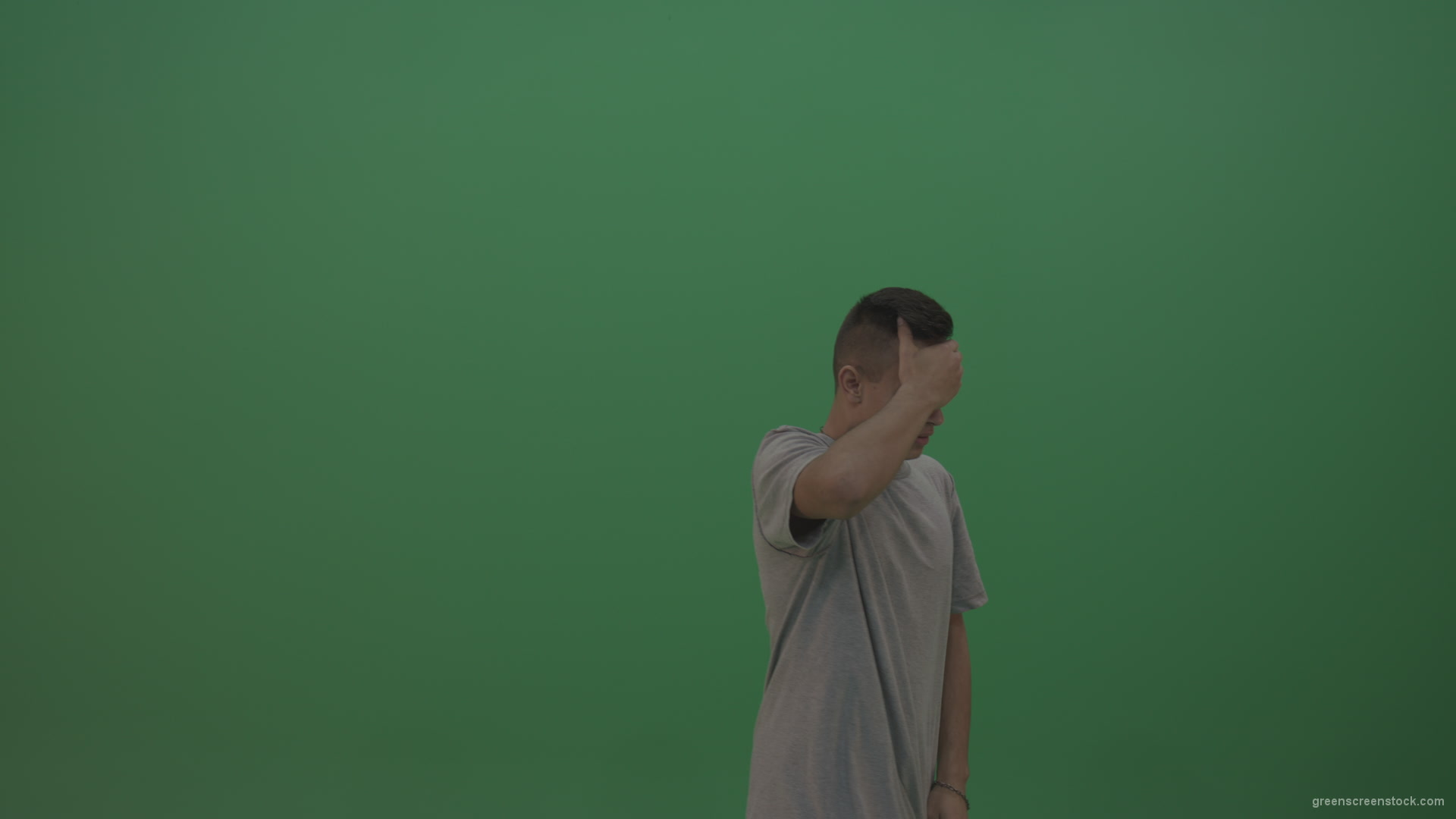 Boy-in-grey-wear-expresses-disappointment-over-green-screen-background_006 Green Screen Stock