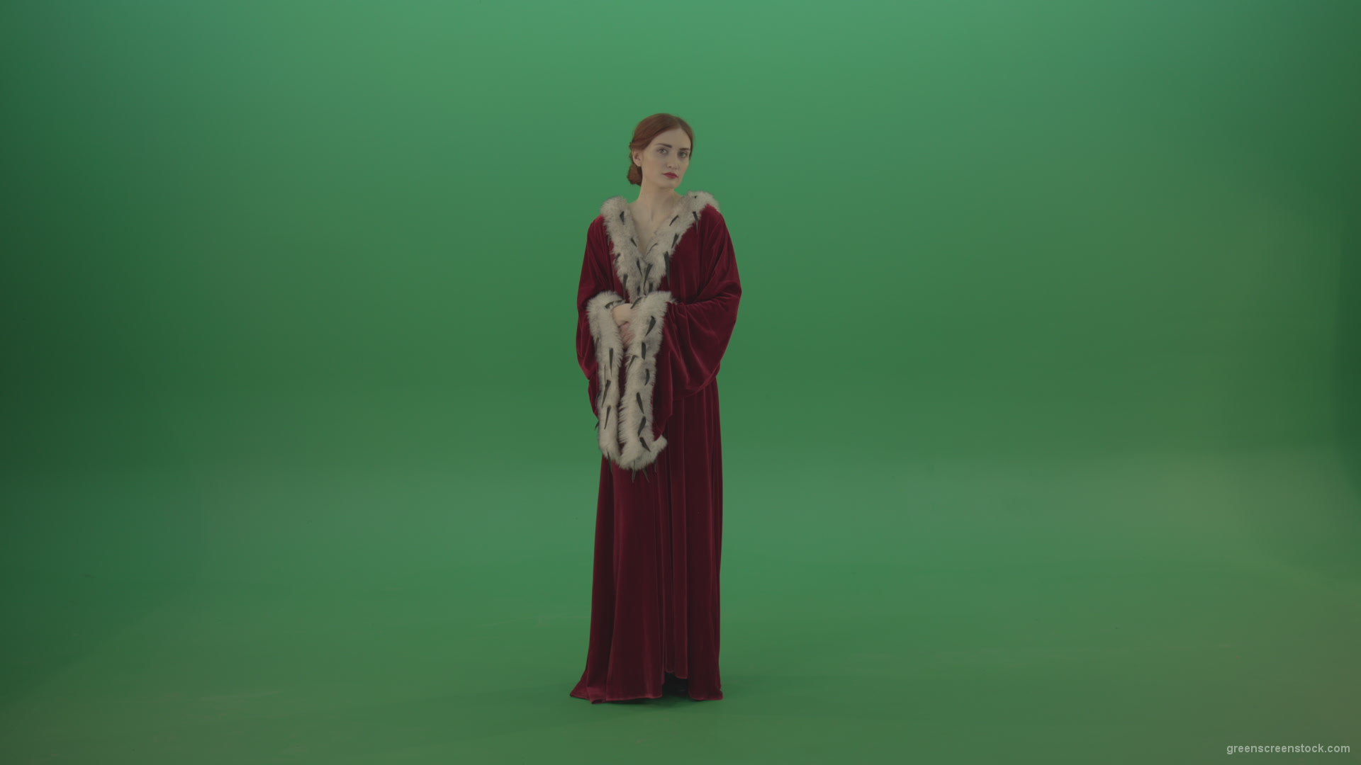 Elegant-woman-princess-with-light-movements-shows-her-beauty-dressed-in-red-cloak-on-a-green-background_001 Green Screen Stock