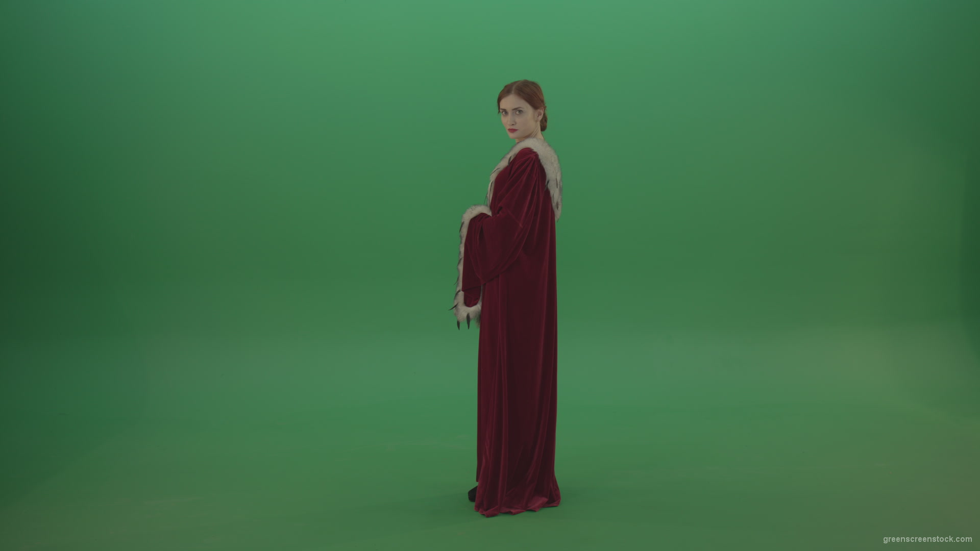 Elegant-woman-princess-with-light-movements-shows-her-beauty-dressed-in-red-cloak-on-a-green-background_007 Green Screen Stock