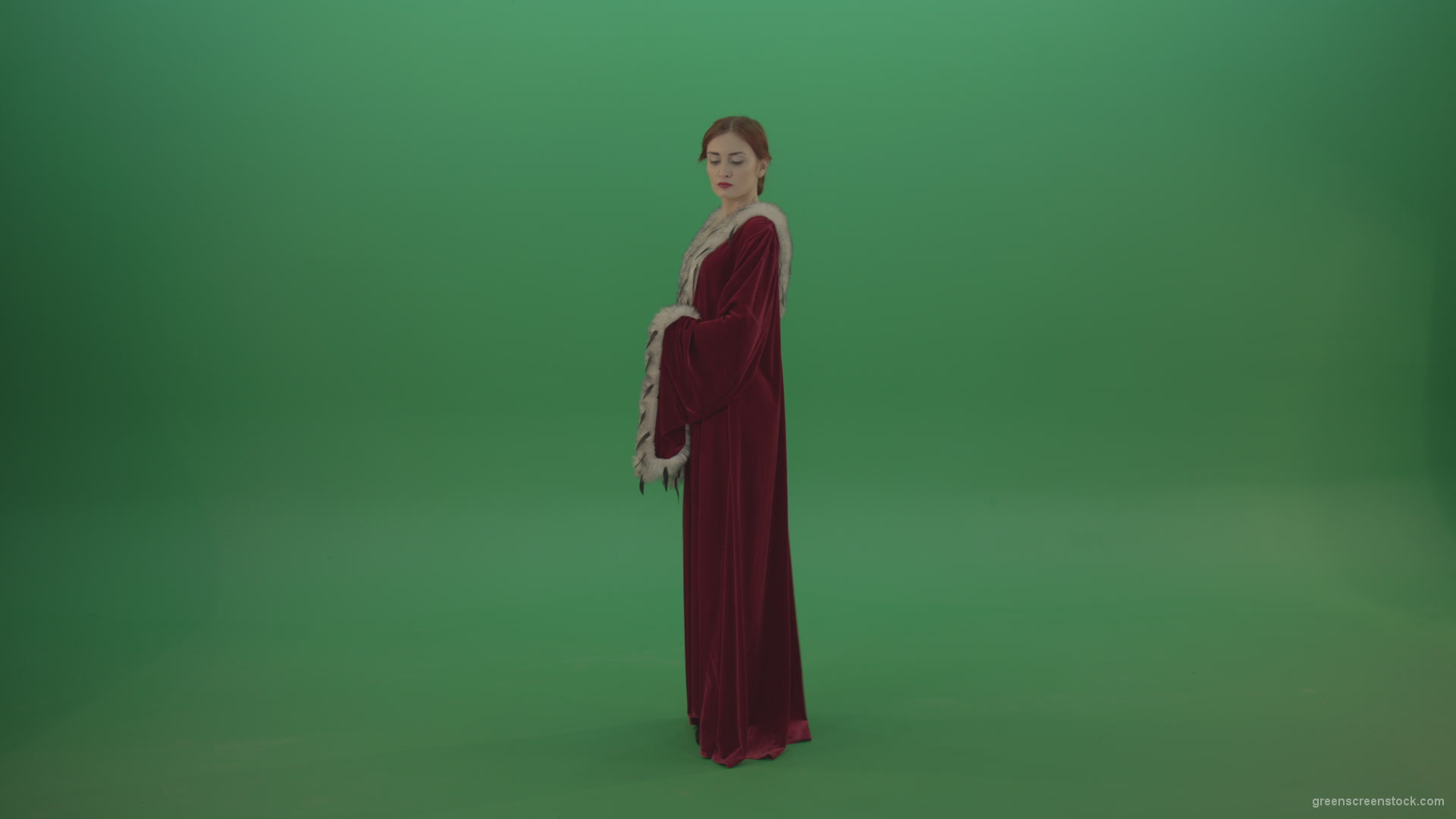 Elegant-woman-princess-with-light-movements-shows-her-beauty-dressed-in-red-cloak-on-a-green-background_008 Green Screen Stock