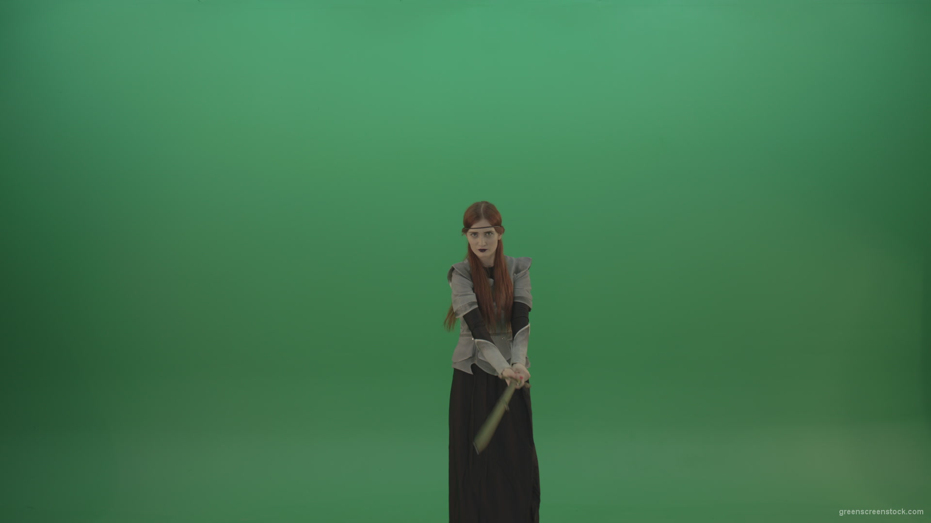 Fighting-girl-in-silver-armor-swinging-with-the-sword-aiming-at-one-goal-on-chromakey_005 Green Screen Stock