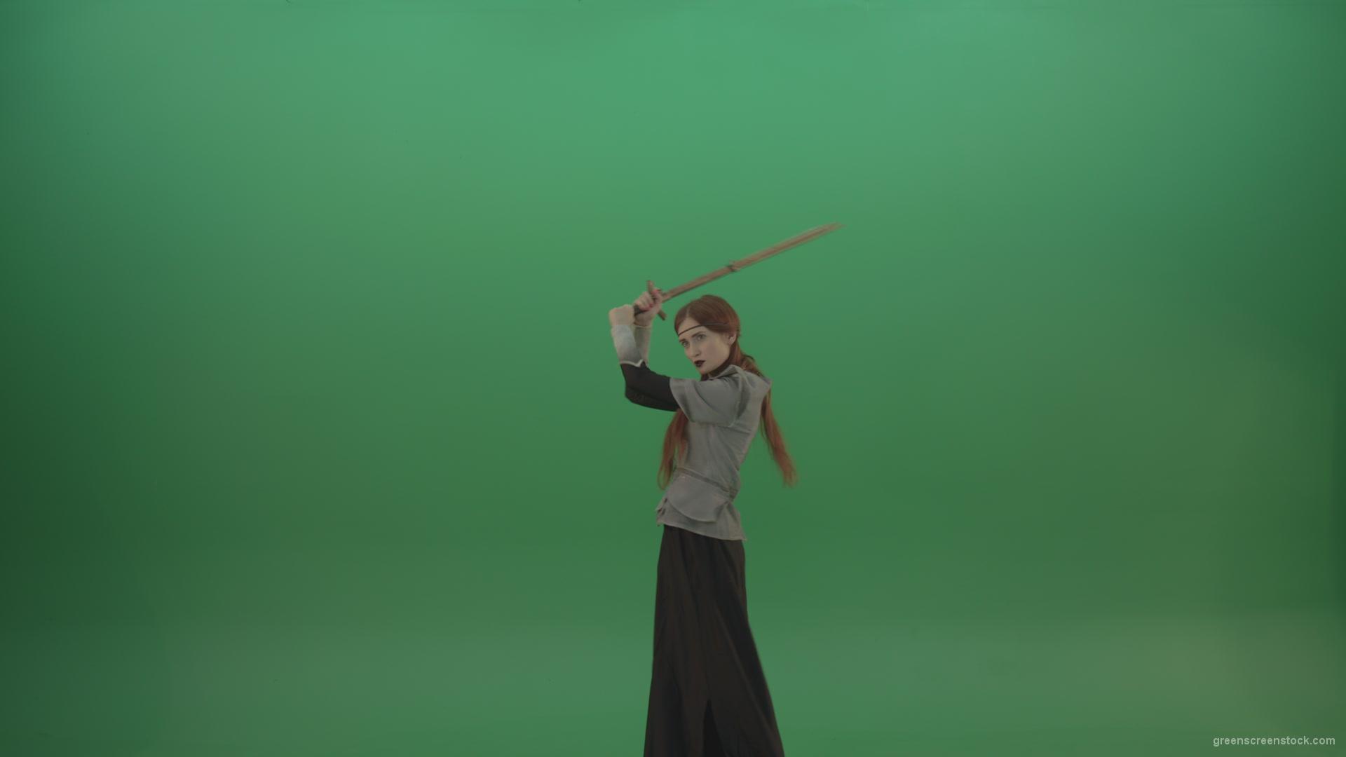 Fighting-girl-in-silver-armor-swinging-with-the-sword-aiming-at-one-goal-on-chromakey_007 Green Screen Stock