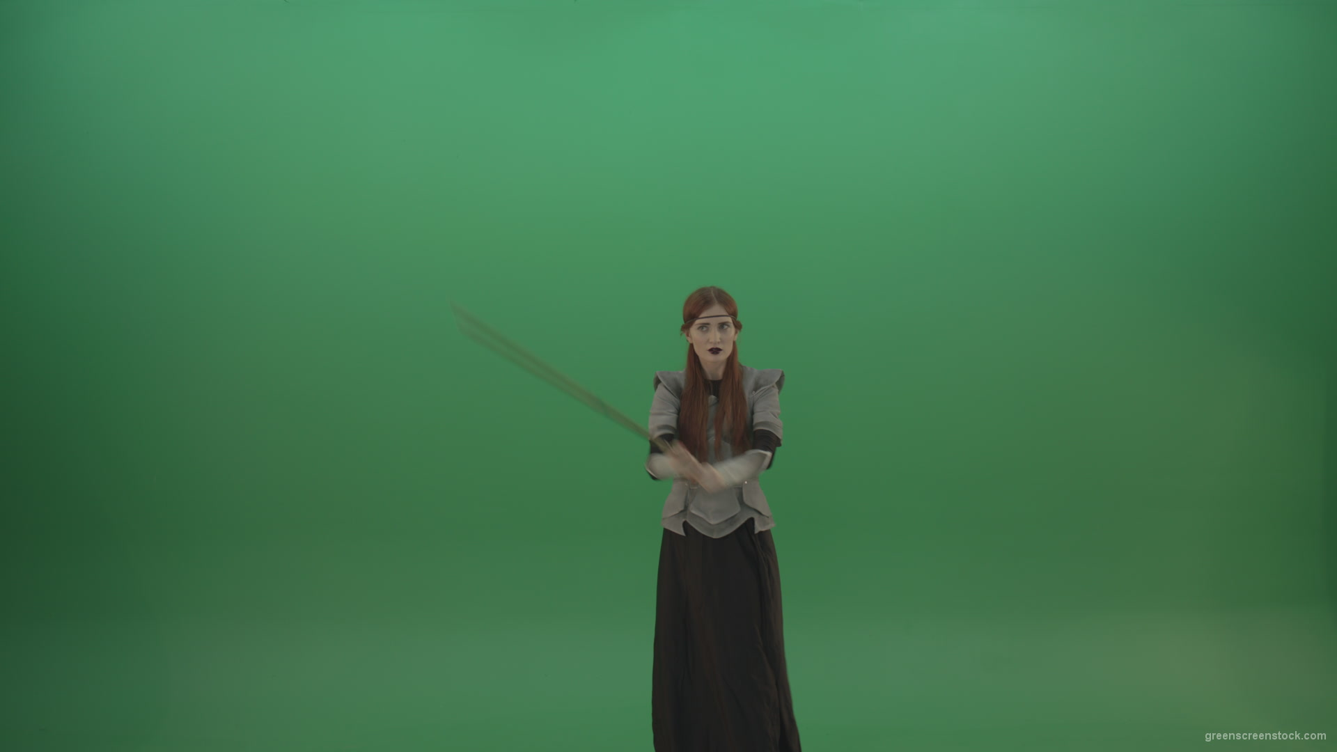 Fighting-girl-in-silver-armor-swinging-with-the-sword-aiming-at-one-goal-on-chromakey_008 Green Screen Stock