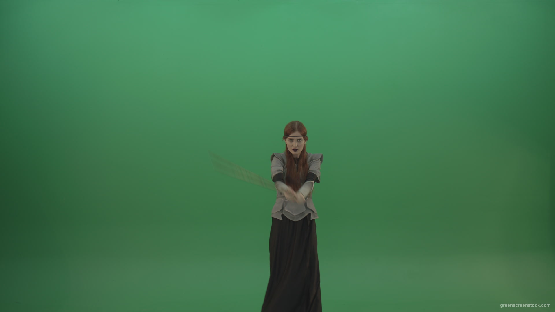 Fighting-girl-in-silver-armor-swinging-with-the-sword-aiming-at-one-goal-on-chromakey_009 Green Screen Stock