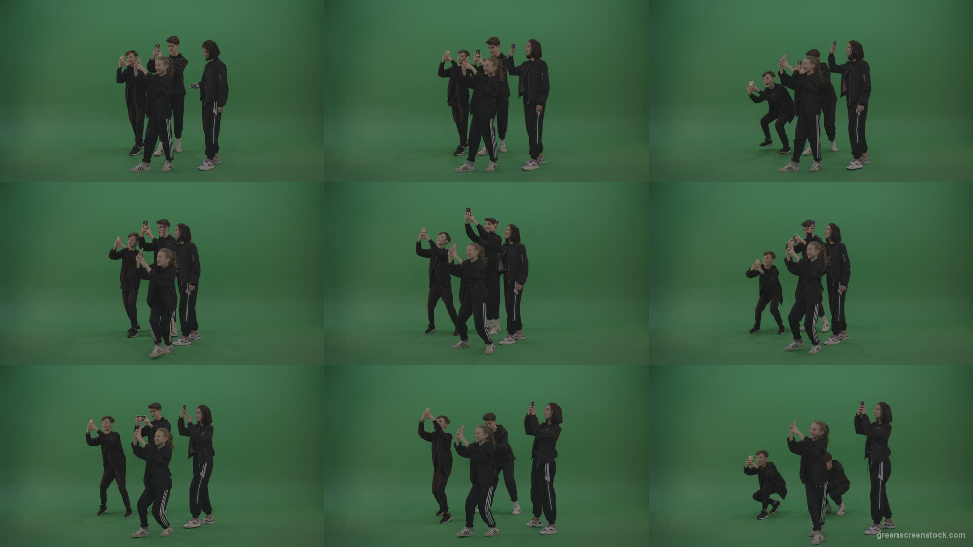 Four-kids-in-black-wears-take-pictures-over-chromakey-background Green Screen Stock