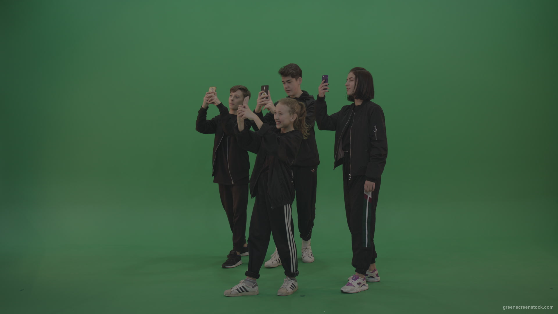 Four-kids-in-black-wears-take-pictures-over-chromakey-background_002 Green Screen Stock