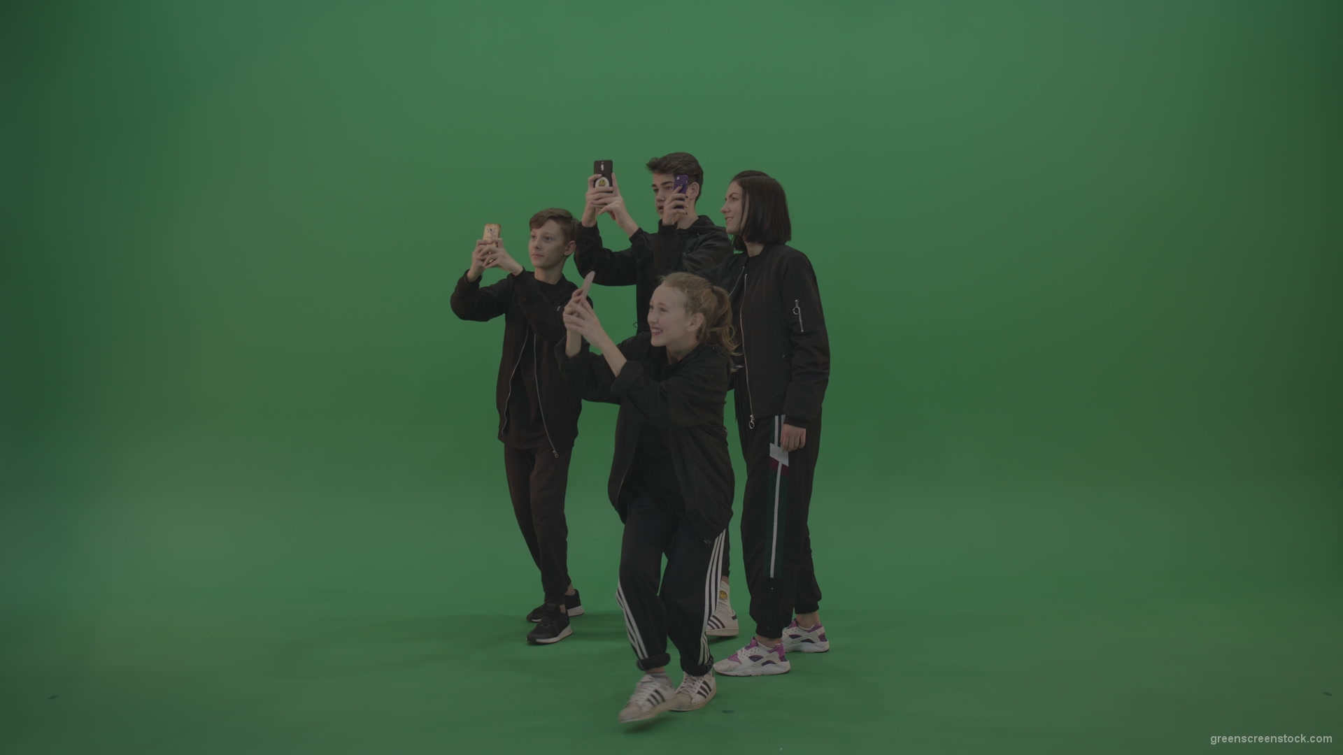 Four-kids-in-black-wears-take-pictures-over-chromakey-background_004 Green Screen Stock