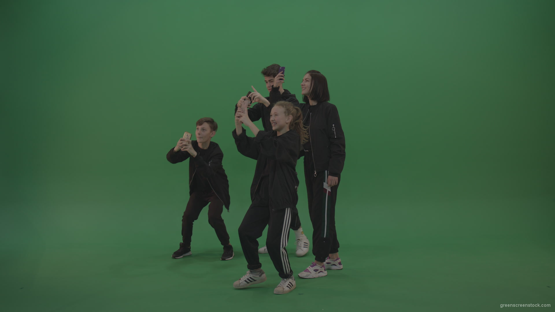 Four-kids-in-black-wears-take-pictures-over-chromakey-background_006 Green Screen Stock