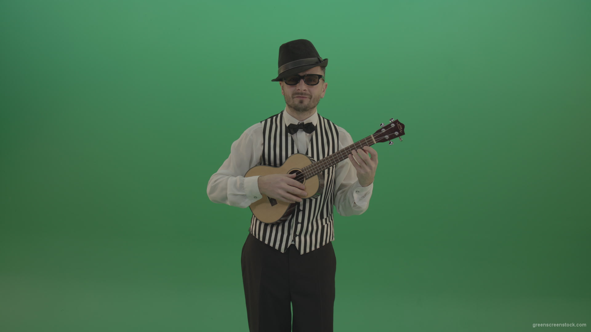 Funny-guitar-player-with-small-classic-guitar-on-chromakey-green-screen_001 Green Screen Stock