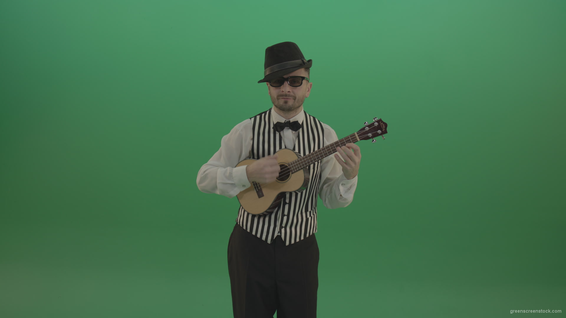 Funny-guitar-player-with-small-classic-guitar-on-chromakey-green-screen_002 Green Screen Stock