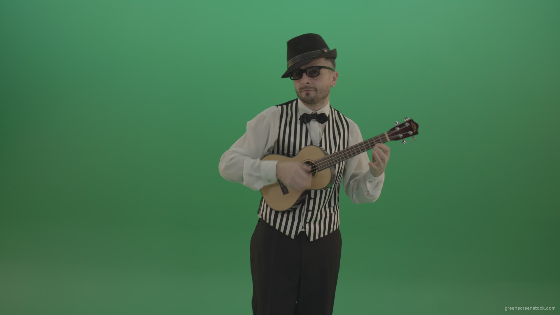 Funny-guitar-player-with-small-classic-guitar-on-chromakey-green-screen_007 Green Screen Stock
