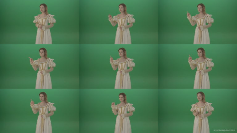 Girl-flips-a-virtual-screen-dressed-in-a-medieval-costume-isolated-on-green-screen Green Screen Stock