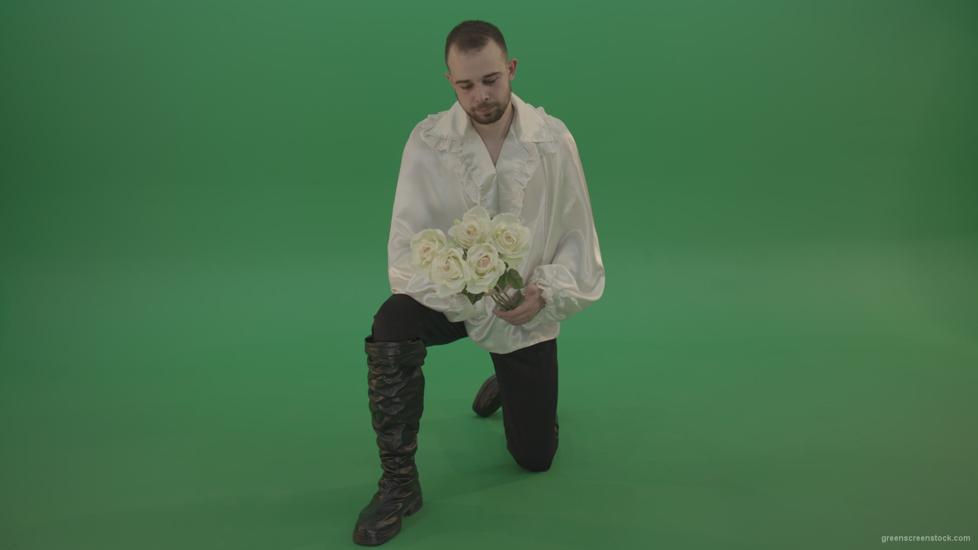 Medieval-man-gives-white-flowers-standing-on-one-knee-isolated-in-green-screen-studio_001 Green Screen Stock