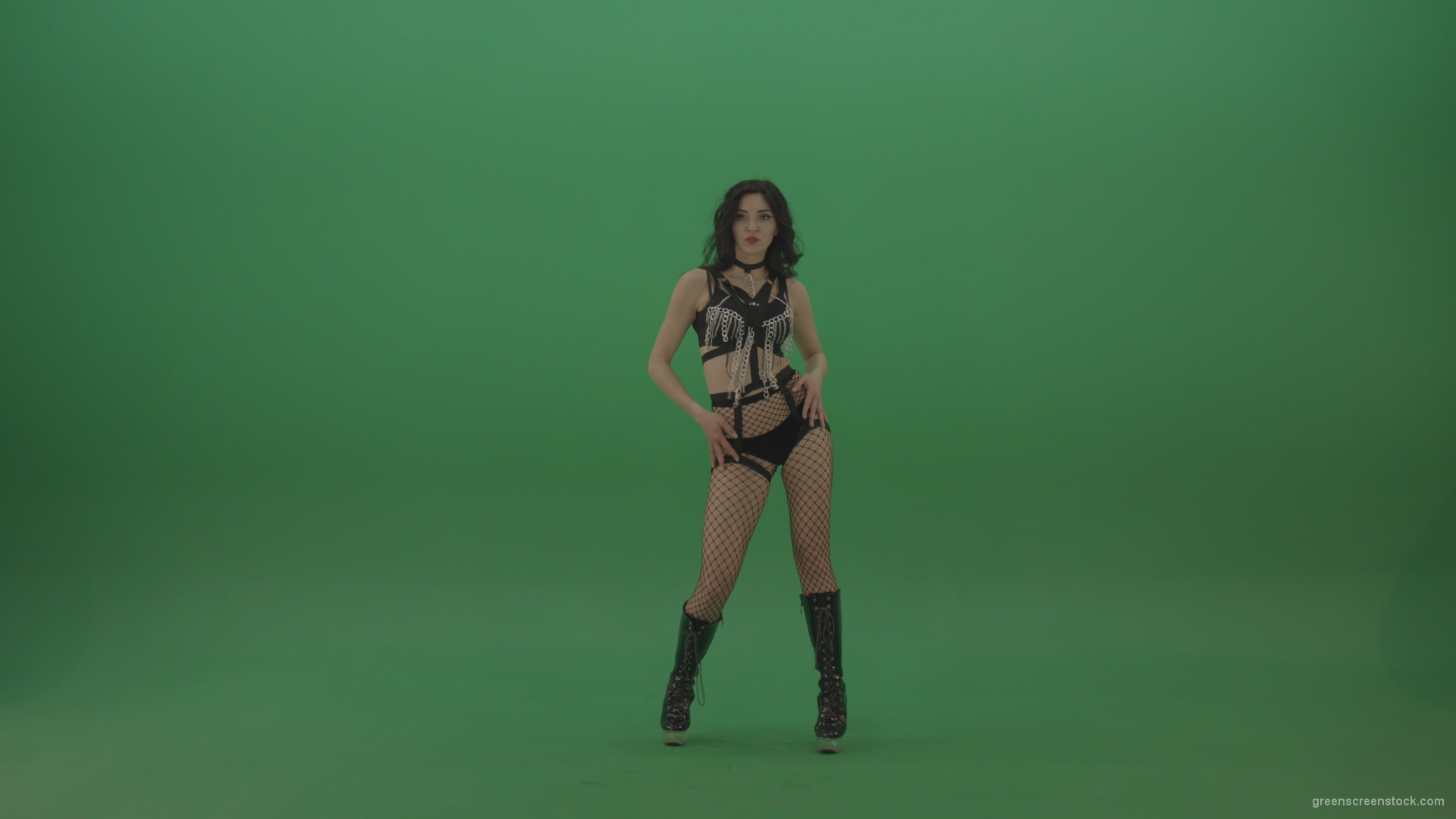 Pretty-black-haired-woman-in-an-erotic-suit-cycles-repetitive-movements-on-green-background._001 Green Screen Stock
