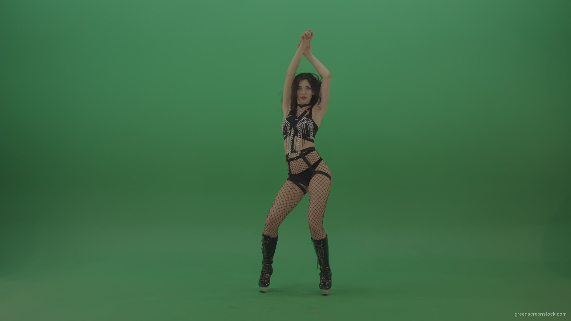 Pretty-black-haired-woman-in-an-erotic-suit-cycles-repetitive-movements-on-green-background._004 Green Screen Stock