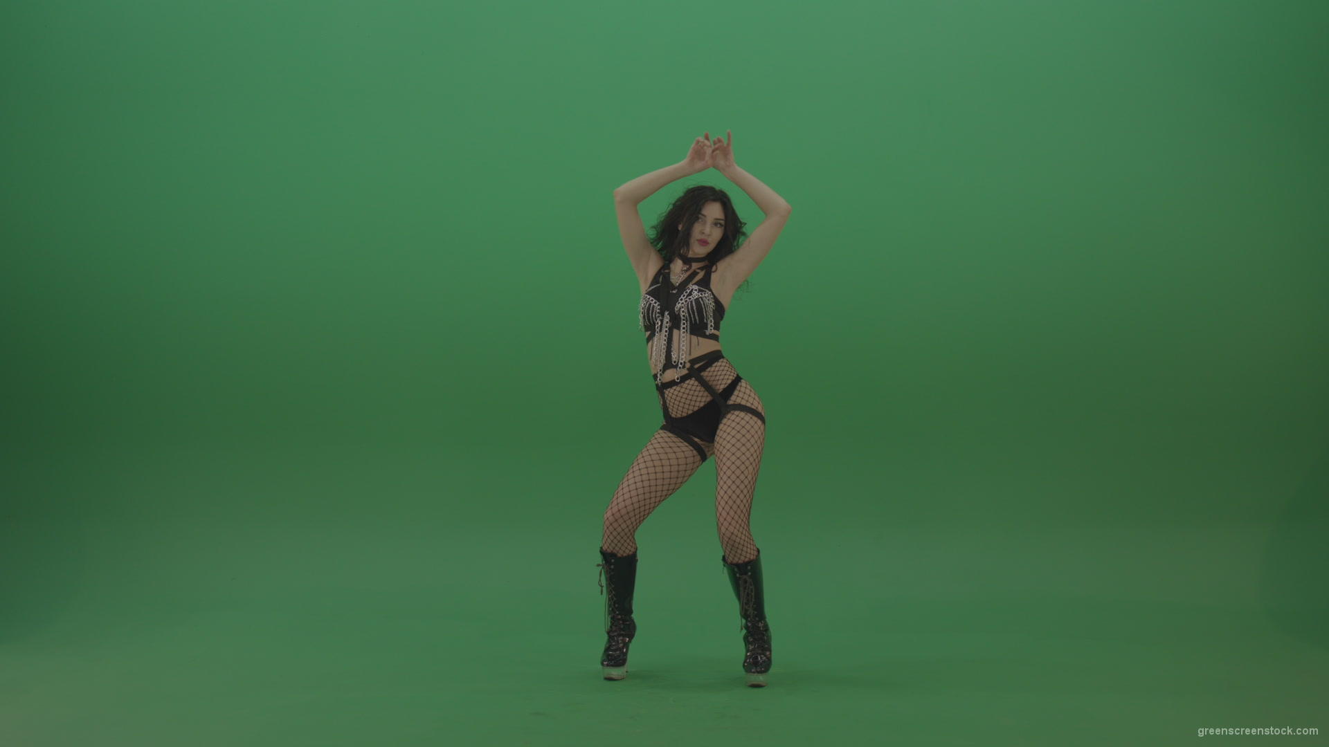 Pretty-black-haired-woman-in-an-erotic-suit-cycles-repetitive-movements-on-green-background._005 Green Screen Stock