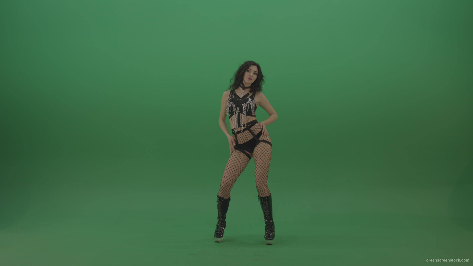 Pretty-black-haired-woman-in-an-erotic-suit-cycles-repetitive-movements-on-green-background._006 Green Screen Stock