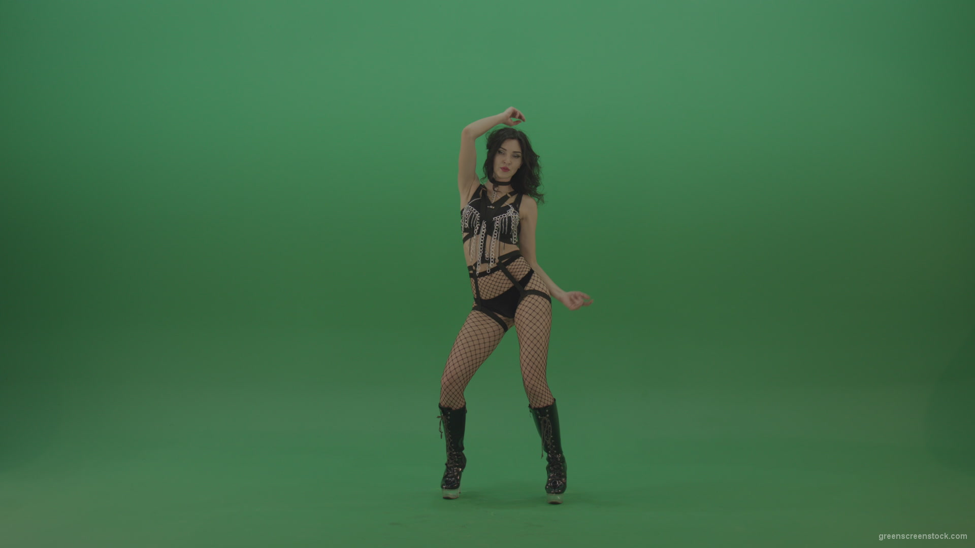 Pretty-black-haired-woman-in-an-erotic-suit-cycles-repetitive-movements-on-green-background._007 Green Screen Stock