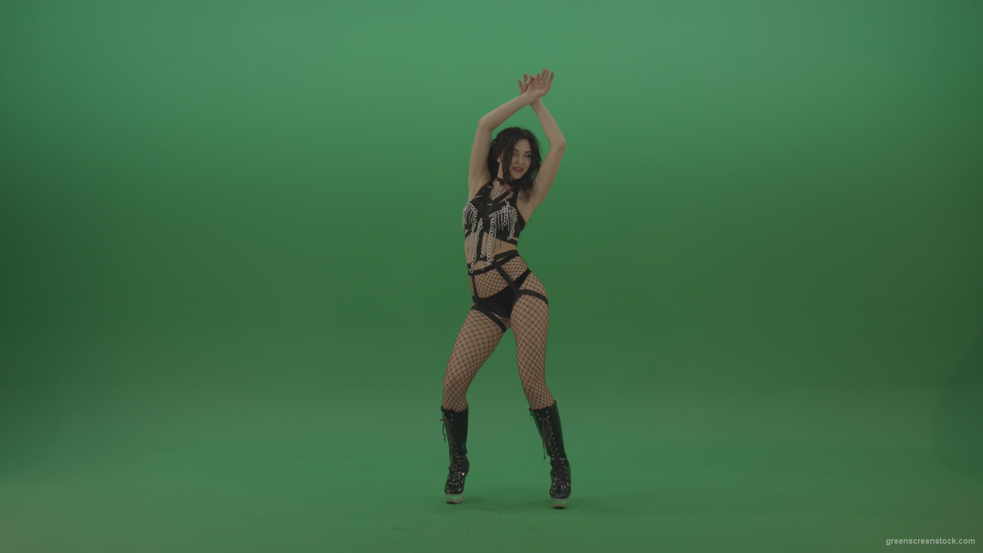 Pretty-black-haired-woman-in-an-erotic-suit-cycles-repetitive-movements-on-green-background._009 Green Screen Stock