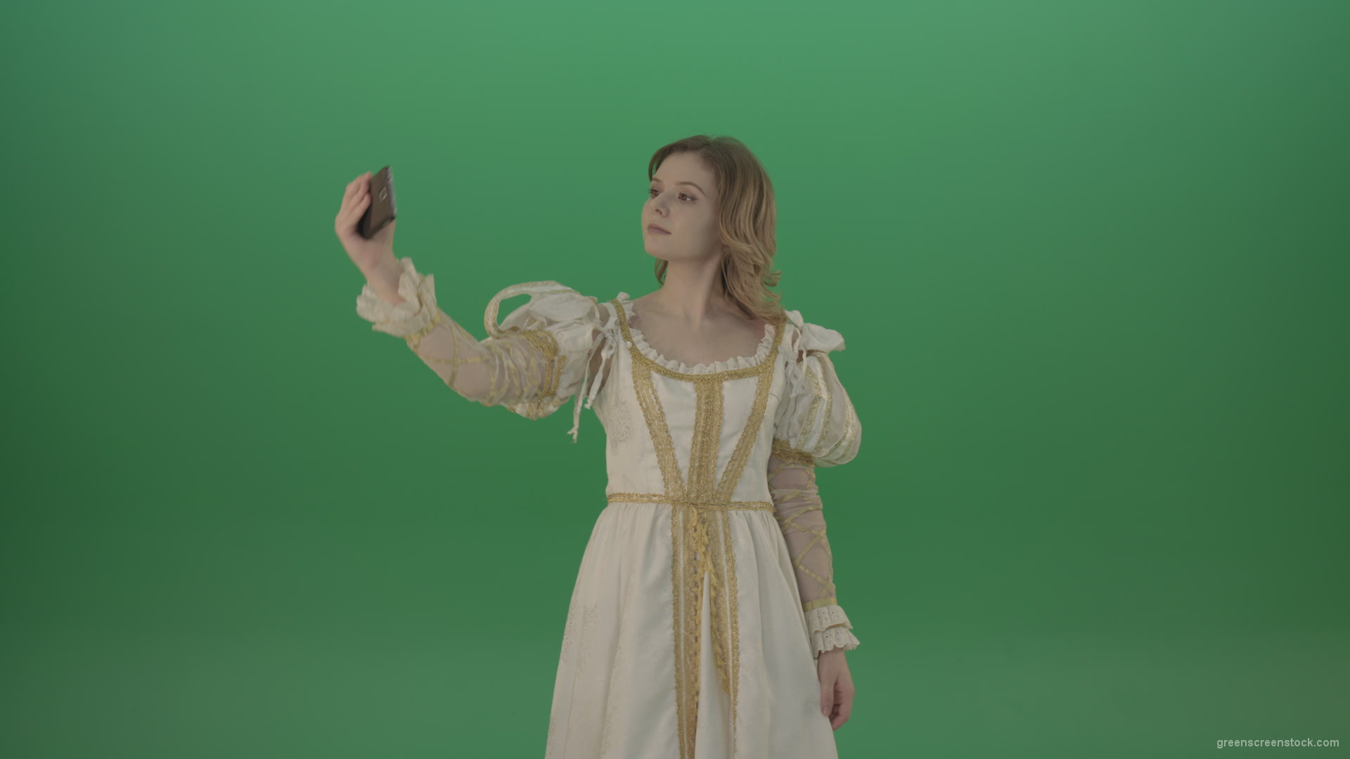 Princess-girl-dressed-in-a-light-suit-makes-a-sephi-on-a-modern-phone-isolated-on-chromakey-background_002 Green Screen Stock