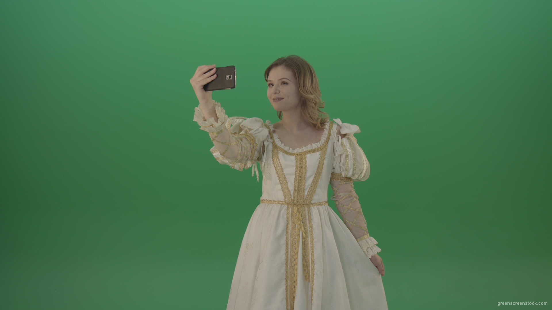 Princess-girl-dressed-in-a-light-suit-makes-a-sephi-on-a-modern-phone-isolated-on-chromakey-background_005 Green Screen Stock