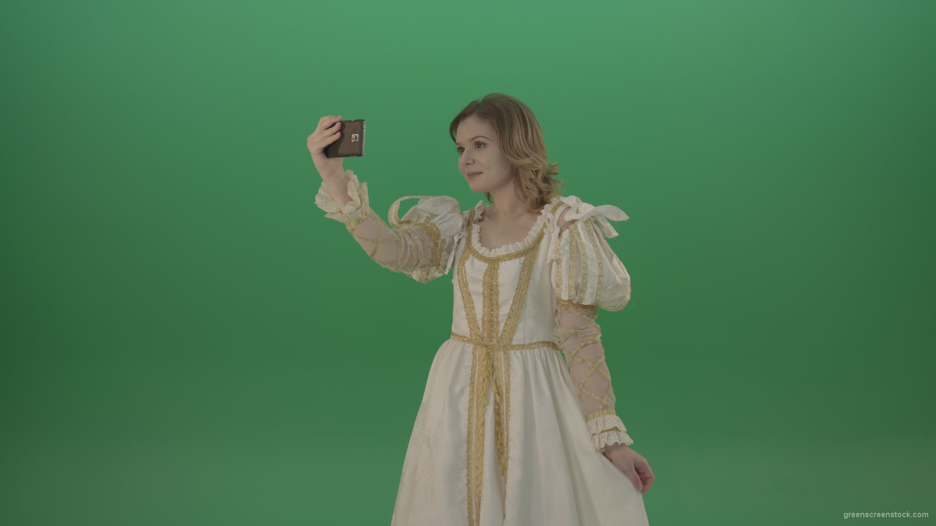Princess-girl-dressed-in-a-light-suit-makes-a-sephi-on-a-modern-phone-isolated-on-chromakey-background_006 Green Screen Stock