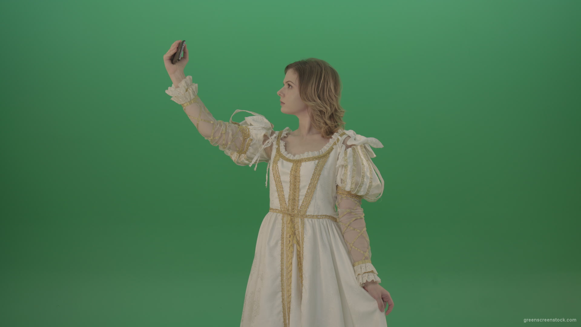 Princess-girl-dressed-in-a-light-suit-makes-a-sephi-on-a-modern-phone-isolated-on-chromakey-background_007 Green Screen Stock