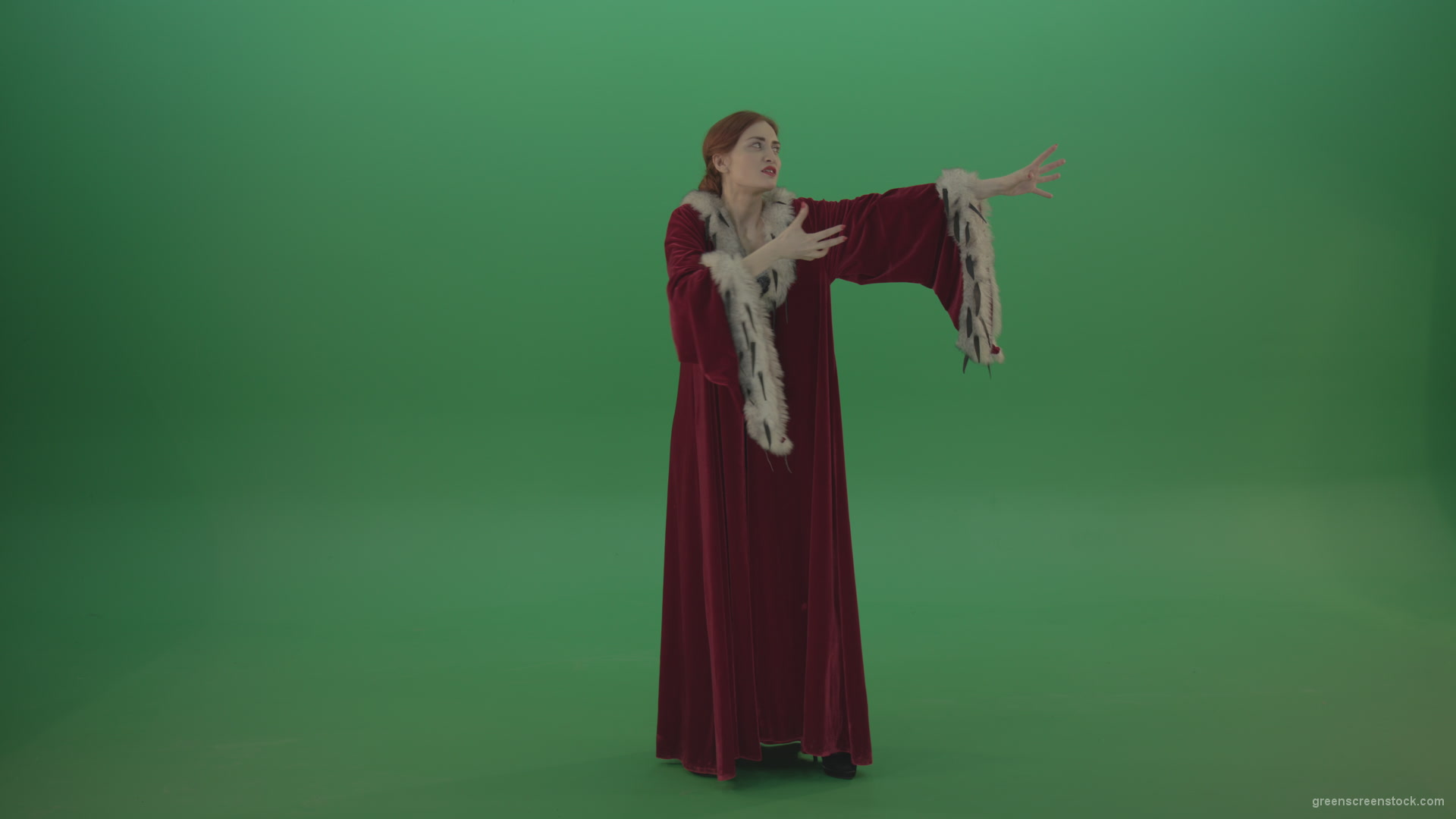 Red-dress-Witch-shooting-black-magic-energy-on-a-green-background_005 Green Screen Stock