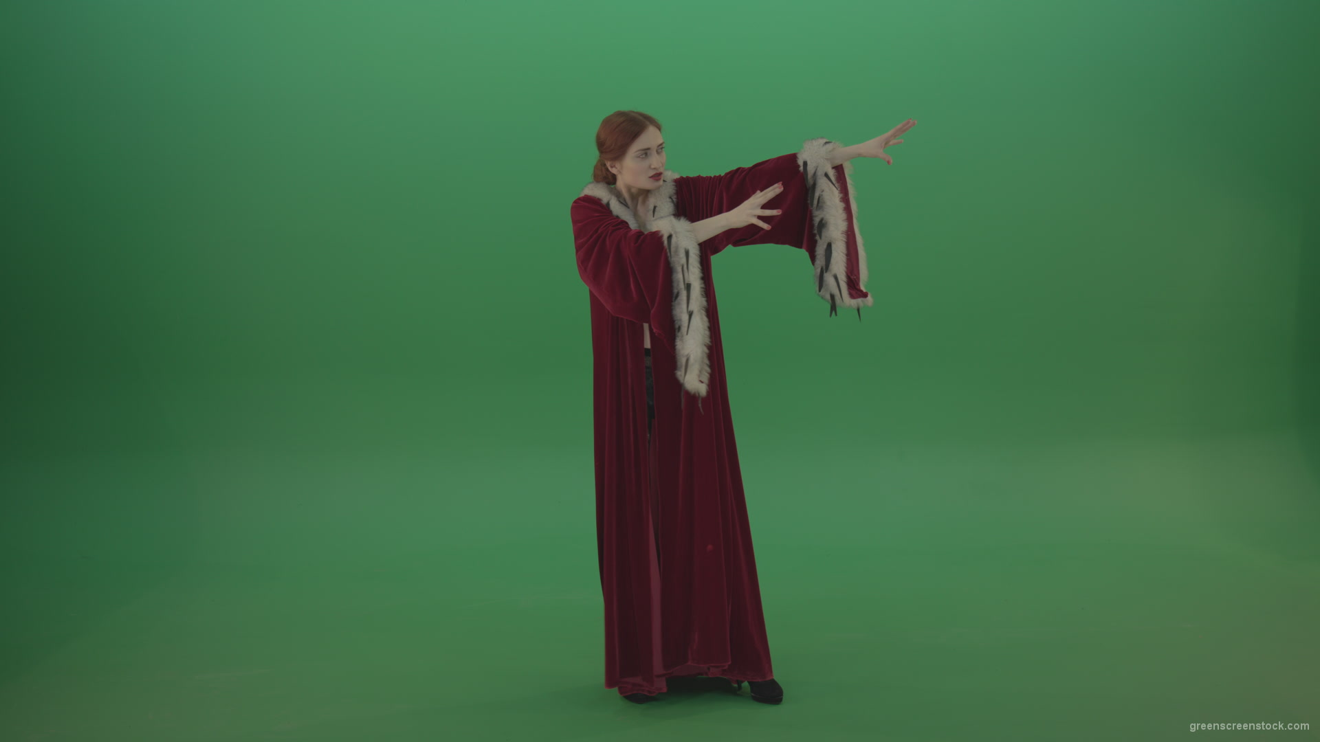 Red-dress-Witch-shooting-black-magic-energy-on-a-green-background_009 Green Screen Stock