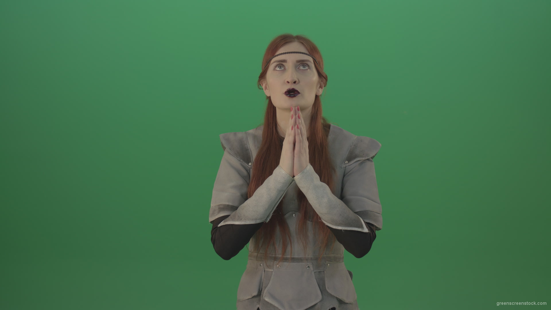 Red-hair-girl-praying-god-in-medieval-warrior-costume-in-green-screen-studio_008 Green Screen Stock