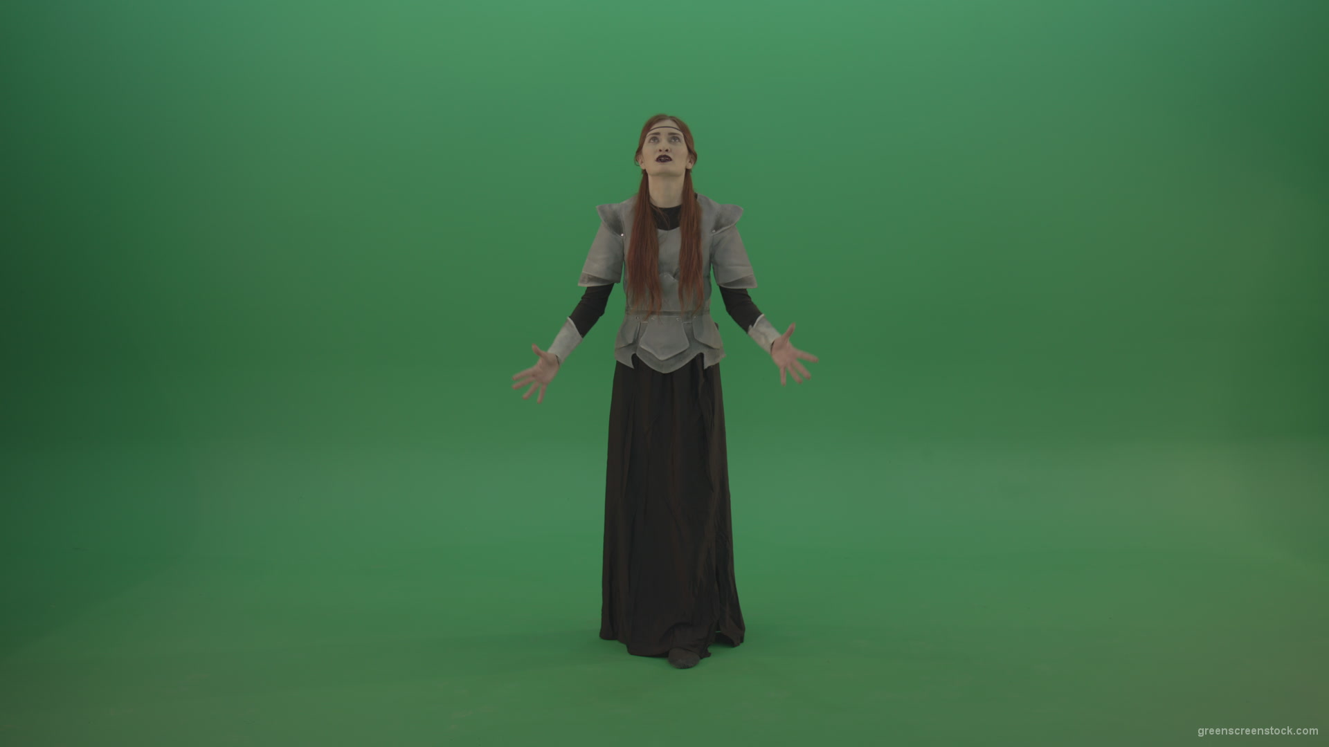 Redheaded-girl-in-full-height-in-medieval-warrior-clothing-asks-for-help-from-the-gods-on-green-screen_004 Green Screen Stock