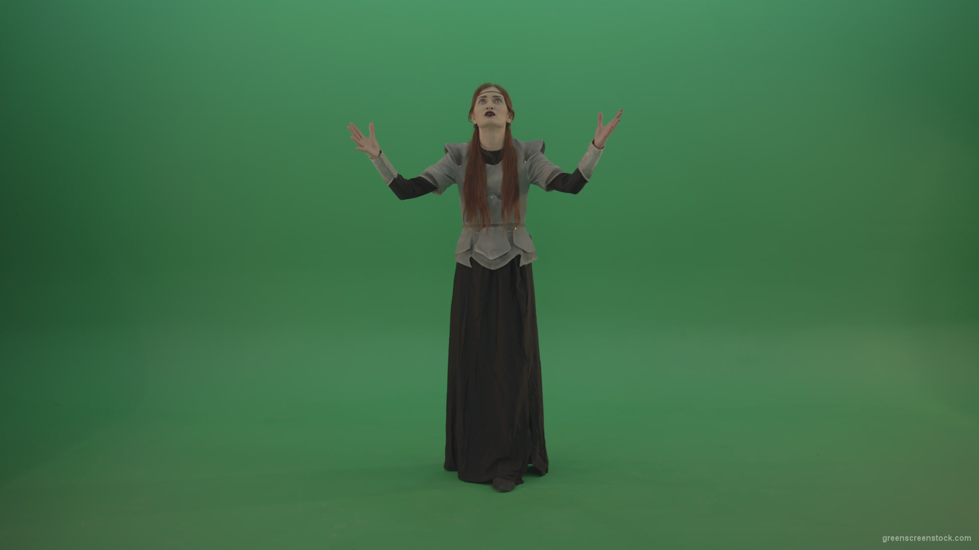 Redheaded-girl-in-full-height-in-medieval-warrior-clothing-asks-for-help-from-the-gods-on-green-screen_005 Green Screen Stock