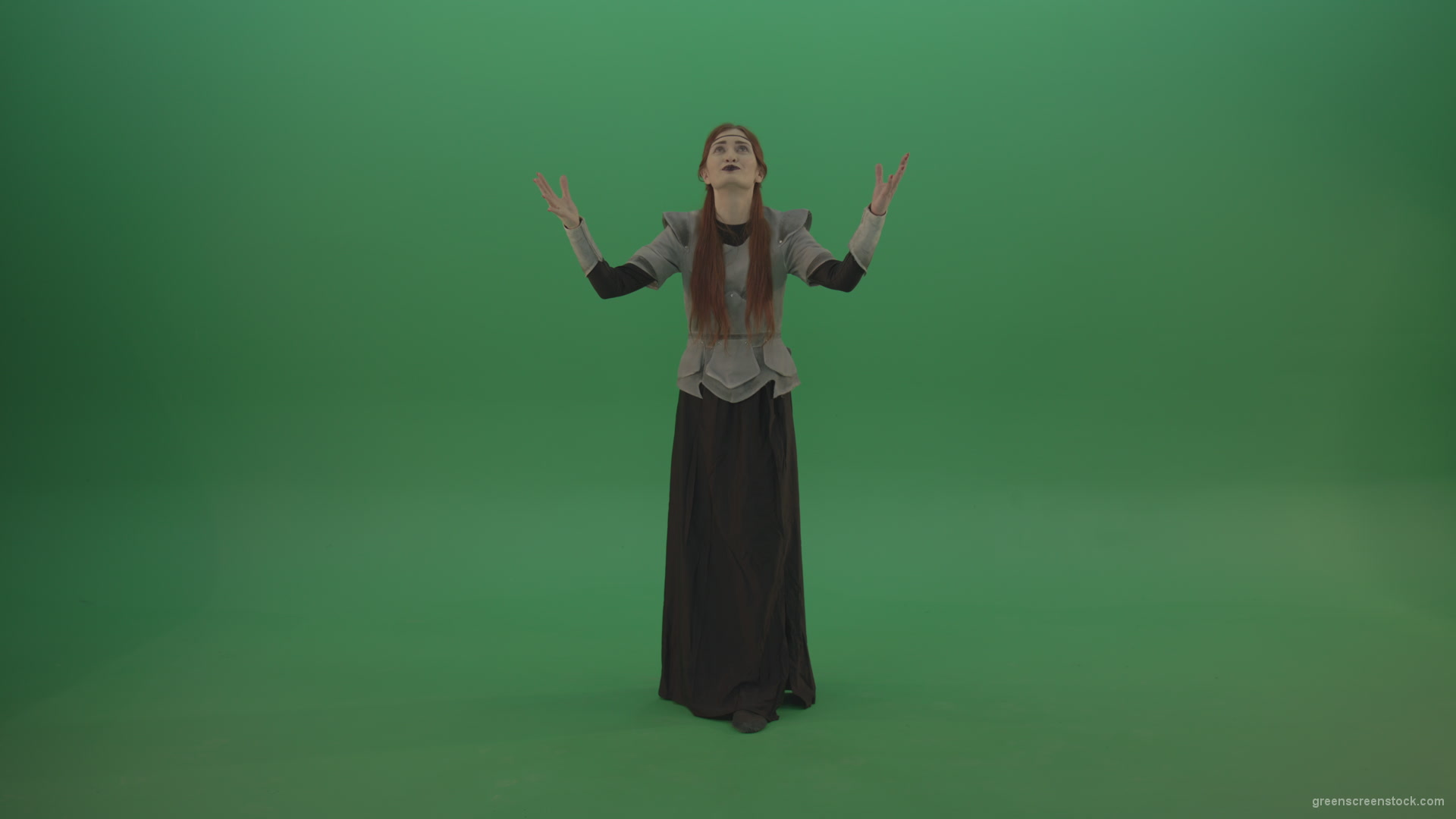 Redheaded-girl-in-full-height-in-medieval-warrior-clothing-asks-for-help-from-the-gods-on-green-screen_006 Green Screen Stock