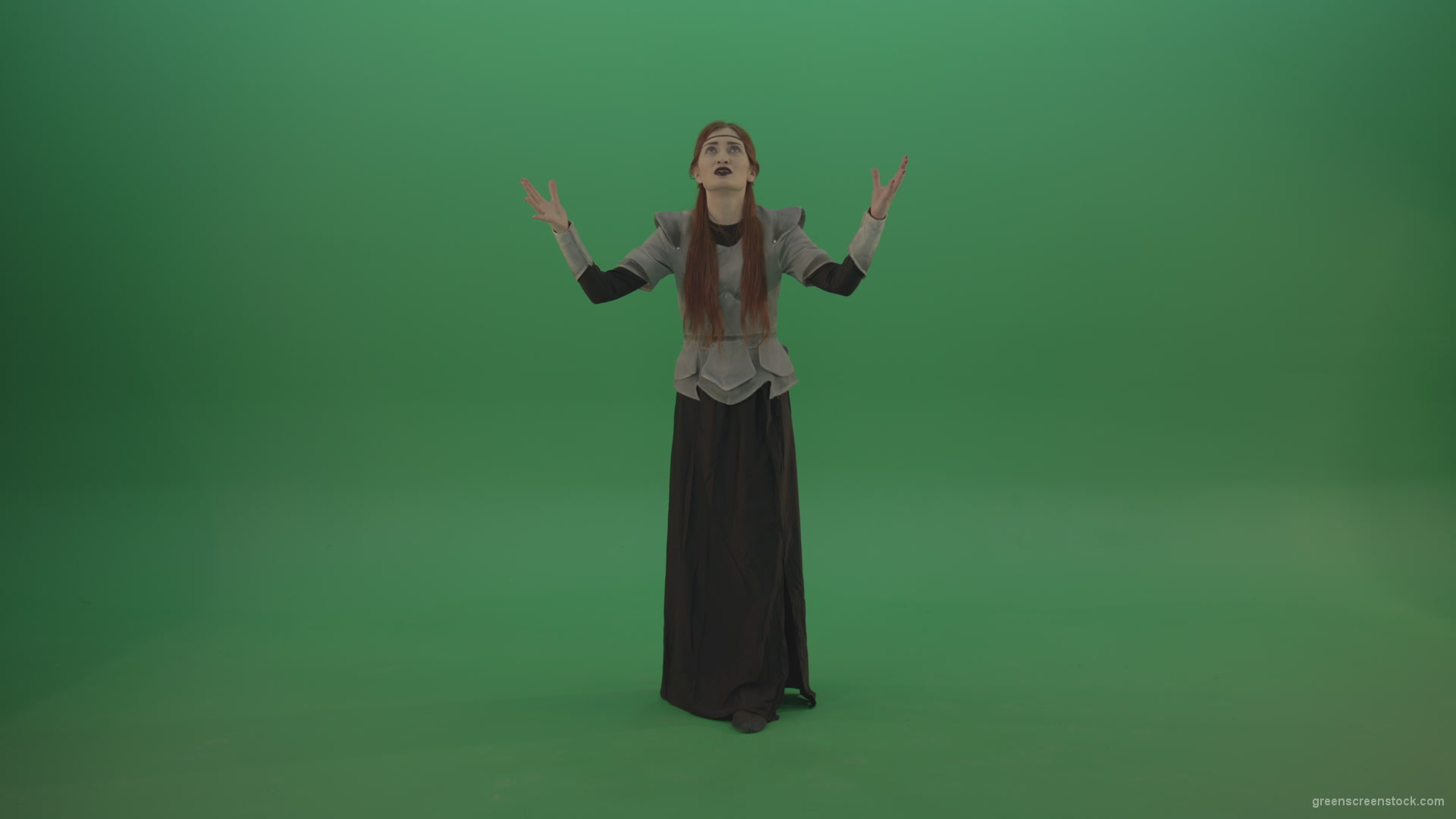 Redheaded-girl-in-full-height-in-medieval-warrior-clothing-asks-for-help-from-the-gods-on-green-screen_007 Green Screen Stock