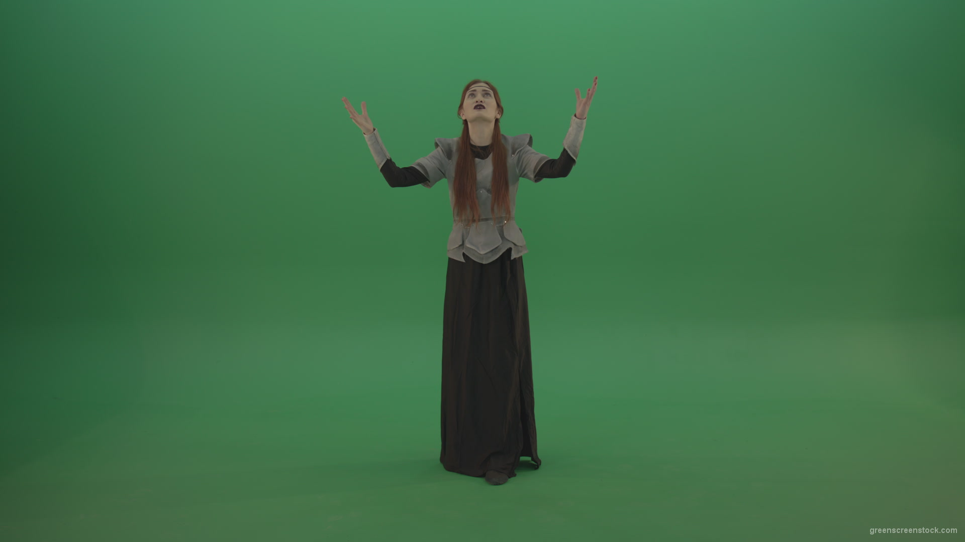 Redheaded-girl-in-full-height-in-medieval-warrior-clothing-asks-for-help-from-the-gods-on-green-screen_008 Green Screen Stock